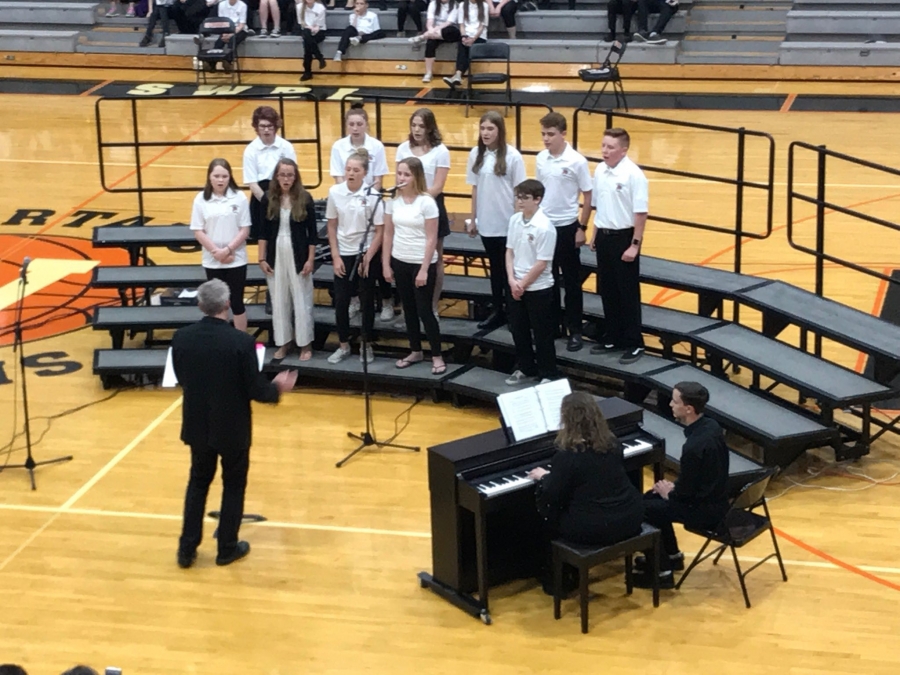 people wearing white shirts standing in risers